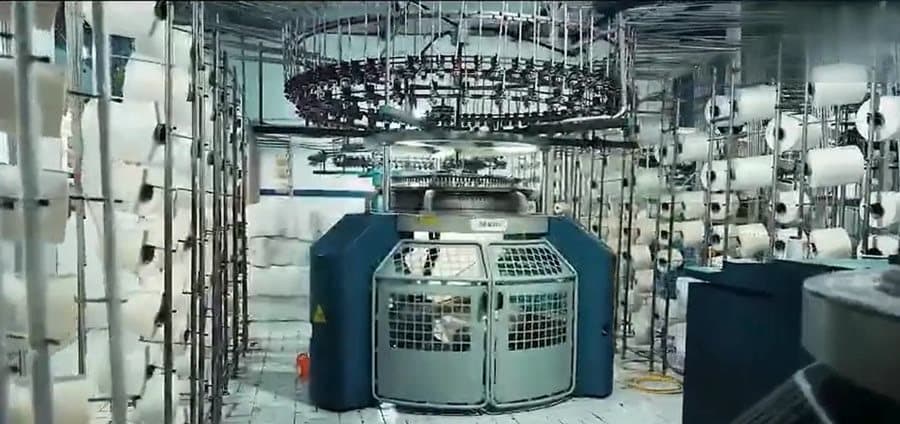 Knitting machines producing fabric
